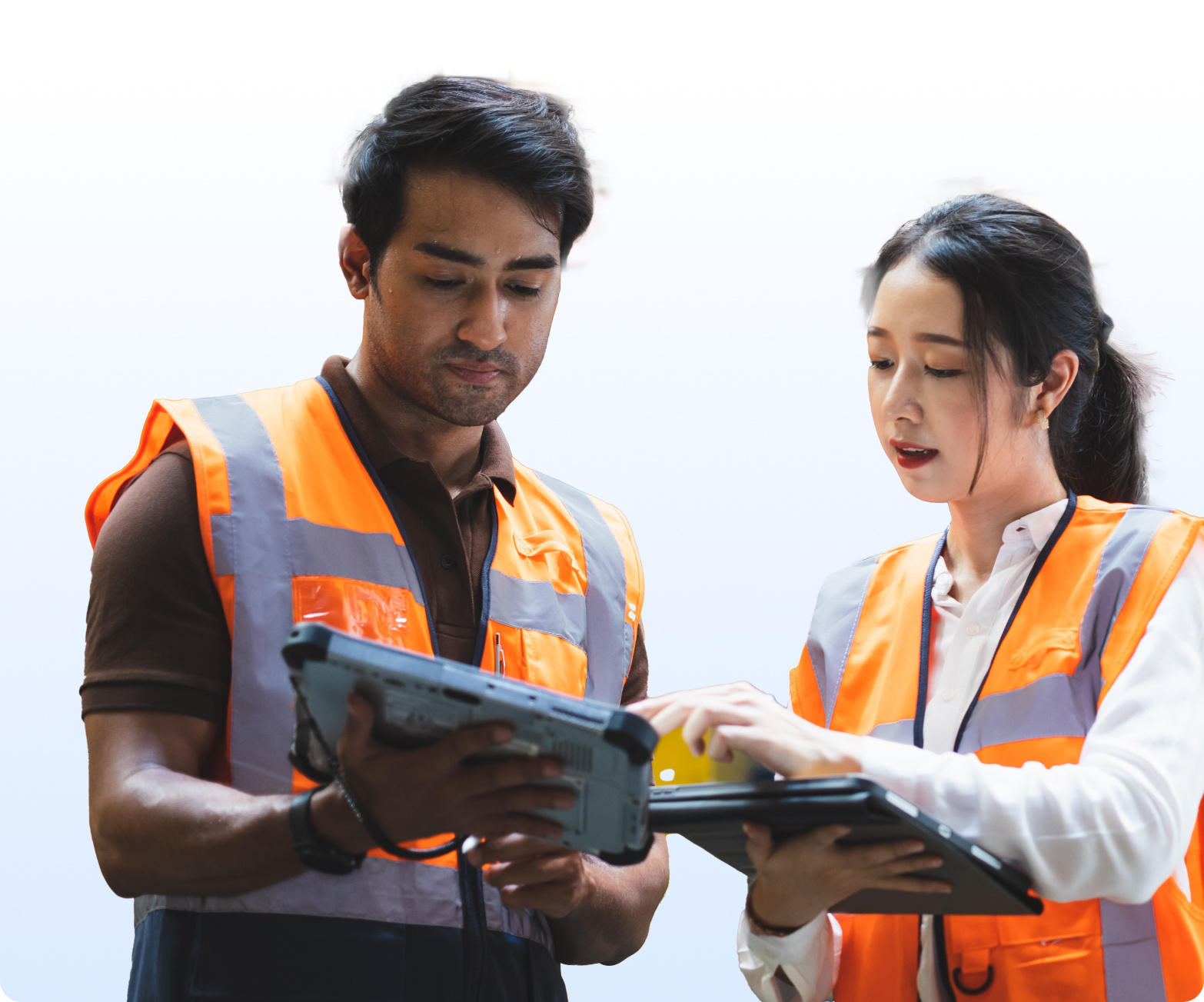 Warehouse team reviewing shipments on tablets